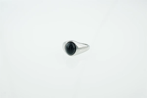 Macro shot of silver polished signet ring featuring a sleek oval black stone inlay