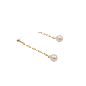 Elegant long gold wavy chain earrings with white freshwater pearls on white background