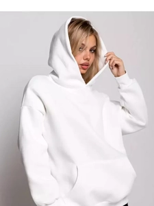 Detail of white oversized hoodie featuring a thick cotton hood and large kangaroo pocket