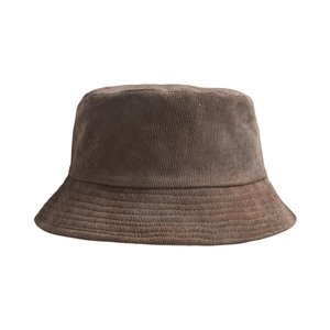 Close-up of deep brown corduroy bucket hat showing vertical ribbed texture and soft fabric