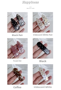 Detail view of colorful rhinestone and pearl acetate hair clips in multiple shades
