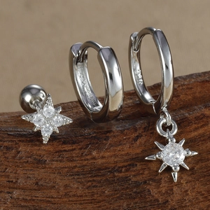 Macro shot of S925 sterling silver star stud and hoop earrings set with zircon stones
