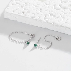 Close-up of S925 silver threader earrings featuring round green zircon stones in prong setting