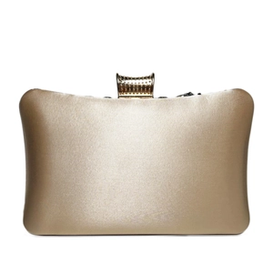 Detail of elegant champagne satin evening clutch with studded gold metal clasp
