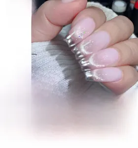 Detail of silver cat-eye French press-on nails with pink gradient and mirror tip finish