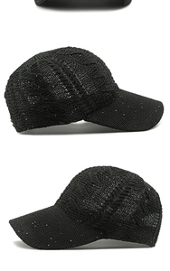 Detail view of black cable-knit mesh baseball cap with subtle sequin embellishments