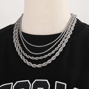Layered silver stainless steel twist rope chain necklace on a black shirt