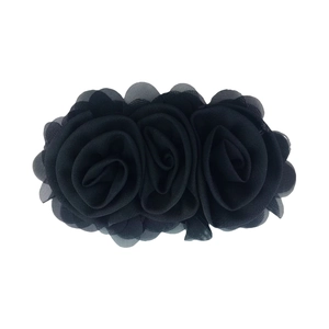 Detailed view of three-layered black chiffon rose hair accessories for children