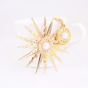 Baroque sun flower and round pendant keychain with pearls on a clean white background