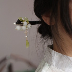 Classical lily of the valley hair stick with tassels and pearls on model hairstyle