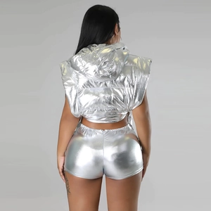 Rear view of women's metallic silver two-piece set featuring hooded vest and tight shorts