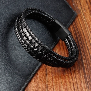 Detail of multi-layer braided black leather bracelet with brushed metal magnetic clasp