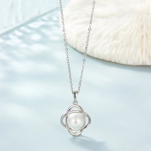 Elegant 925 sterling silver necklace featuring a white pearl in a cross metal frame