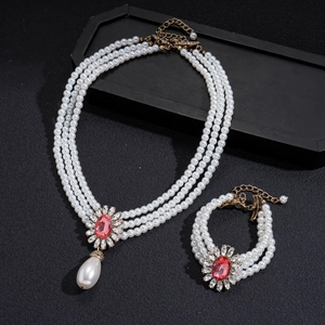Baroque multi-layer pearl necklace and bracelet set with ruby red stones and gold accents