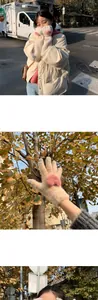 Detail of cream plush gloves with pink cat paw design and ribbed cuffs for winter warmth
