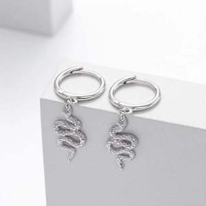 Detail of silver snake pendant earrings with scale texture on minimalist hoop