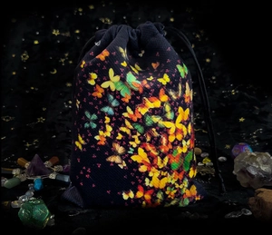 Detail of tarot velvet drawstring bag with colorful butterflies and crystal accessories