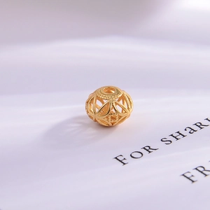 Macro shot of gold-plated S925 sterling silver hollow lotus bead with intricate engravings