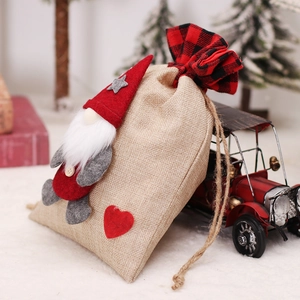 Linen Christmas gnome drawstring gift bag with a 3D faceless doll on a festive red truck