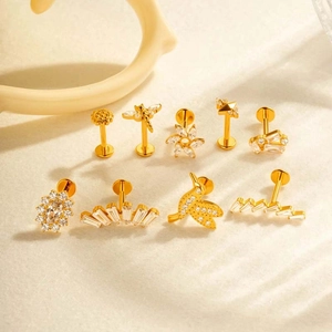 Set of gold G23 titanium flower and animal labret studs with cubic zirconia gems