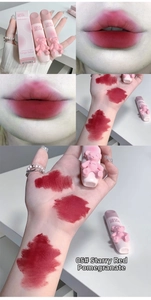 Macro details of glossy berry red lip glaze with 3D bear design on tube and packaging
