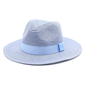 Detail of light blue straw panama hat with matching ribbon bow for sun protection