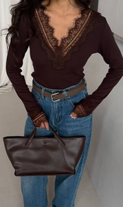 Detailed view of dark brown lace V-neck long sleeve top with intricate floral lace trim