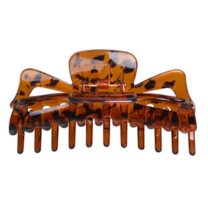 Detail of large tortoiseshell claw clip with strong metal spring and glossy resin finish