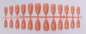 Detailed view of 24-piece nude almond-shaped press-on nails on a plastic runner tray