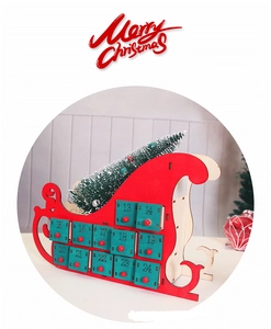 Detailed view of a red wooden sleigh advent calendar with numbered gift drawers