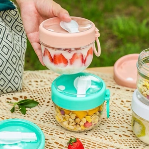 Portable overnight oats containers with lids and spoons for yogurt and fruit snacks