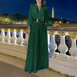 Detail of elegant V-neck satin top and sequin maxi skirt with metallic belt