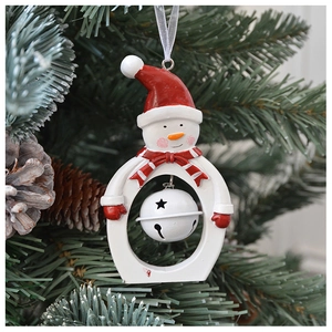 Close-up of a resin snowman ornament with a hollow bell hanging on a green Christmas tree