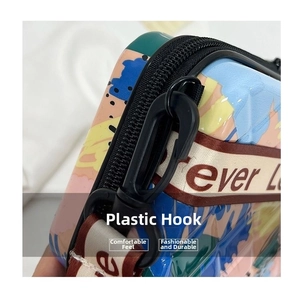 Détail d'un crochet en plastique noir mat sur une pochette aux motifs graffiti colorés