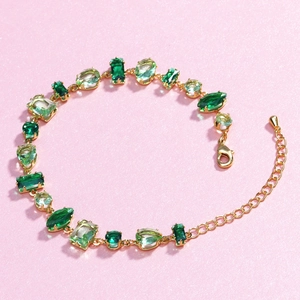 Fashionable gold-plated bracelet featuring green zircon gemstones in diverse geometric shapes