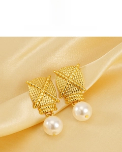 Detailed macro view of 18K gold plated textured metal and glossy white pearl earrings