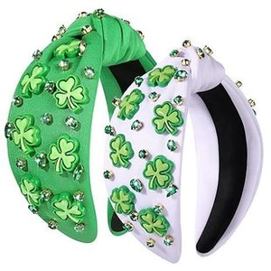 Detail of green and white knotted headbands with clover patterns and sparkling rhinestones