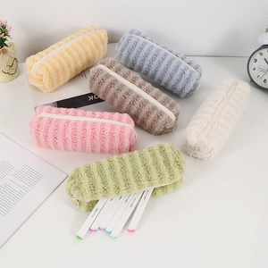 Close-up of plush striped pencil cases in multiple colors with smooth zipper detail