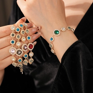 Detailed close-up of colorful crystal bracelets with gold plating and adjustable chain links