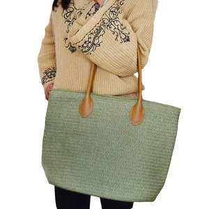 Green handmade woven straw tote bag with brown handles for daily casual use
