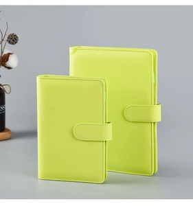 Detail of lime green macaron PU leather ring binder with magnetic buckle closure