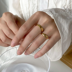 Star and moon engraved gold rings set with zircon stones worn on fingers