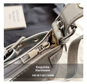 Close-up of silver metallic baguette bag showing polished zipper and grommet strap details