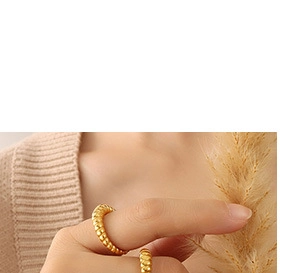 Detail of 18K gold plated croissant ring showing twisted metal texture on female hand