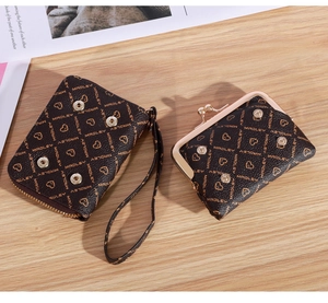Detail of coffee brown textured wallet and coin purse set with gold hardware on wood
