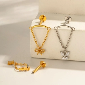 Titanium butterfly bow piercing studs with hanging chains in gold and silver finish