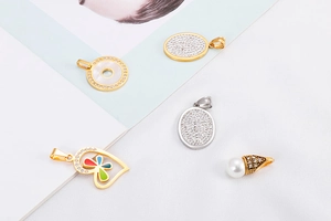 Flat lay of multiple hollow heart and geometric pendants in gold and silver finish