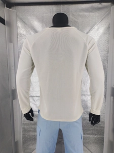 Macro detail of men's waffle knit texture on back of cream raglan long sleeve shirt