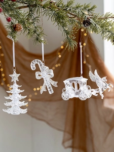 Close-up of transparent acrylic Christmas tree ornaments with silver glitter finish