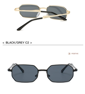 Detail of polygon metal frame sunglasses in black and grey finish with golden temples